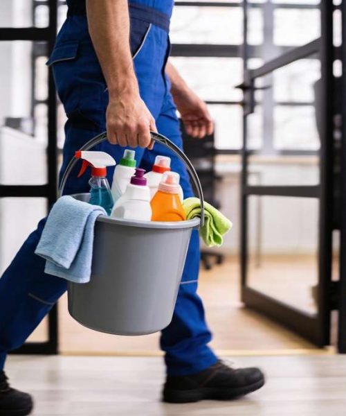 Professional,Cleaning,Worker,Wearing,Uniform,And,Walking,Indoors,While,Carrying