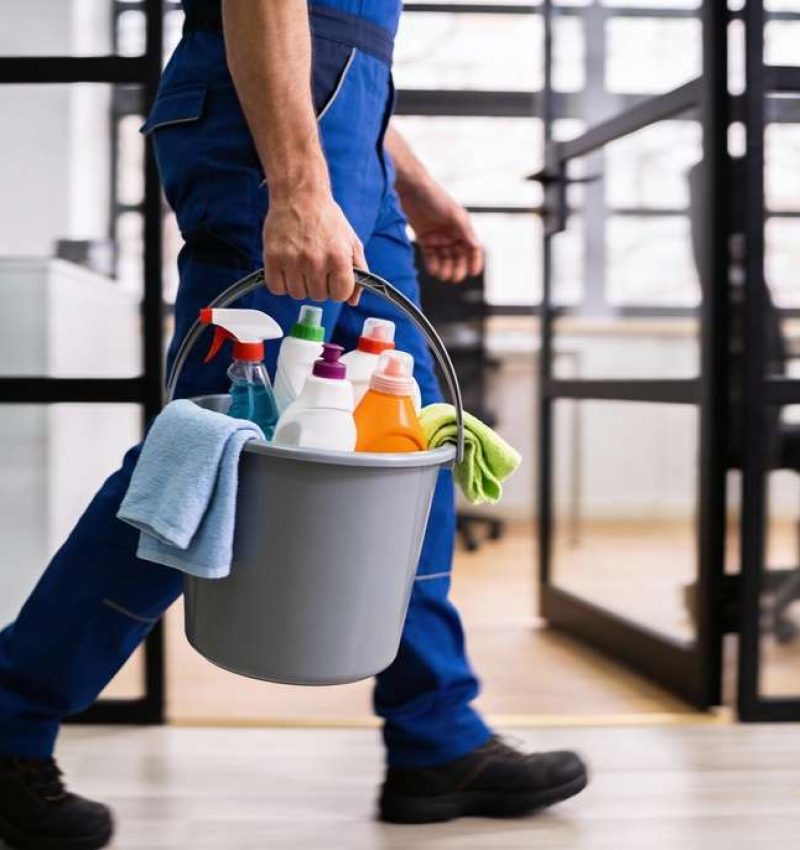 Professional,Cleaning,Worker,Wearing,Uniform,And,Walking,Indoors,While,Carrying