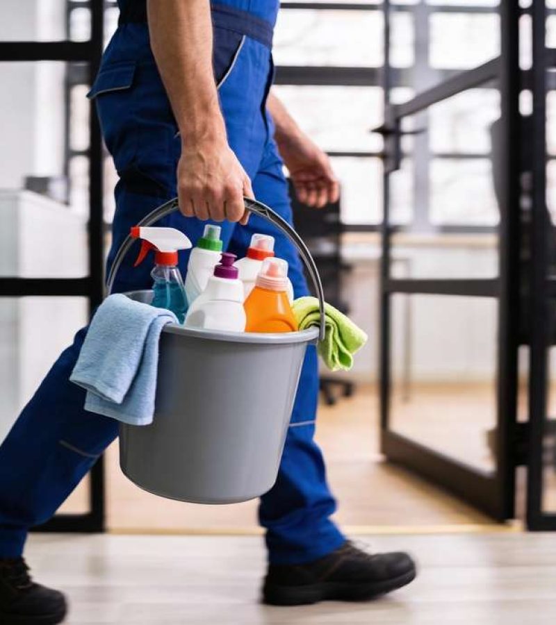 Professional,Cleaning,Worker,Wearing,Uniform,And,Walking,Indoors,While,Carrying