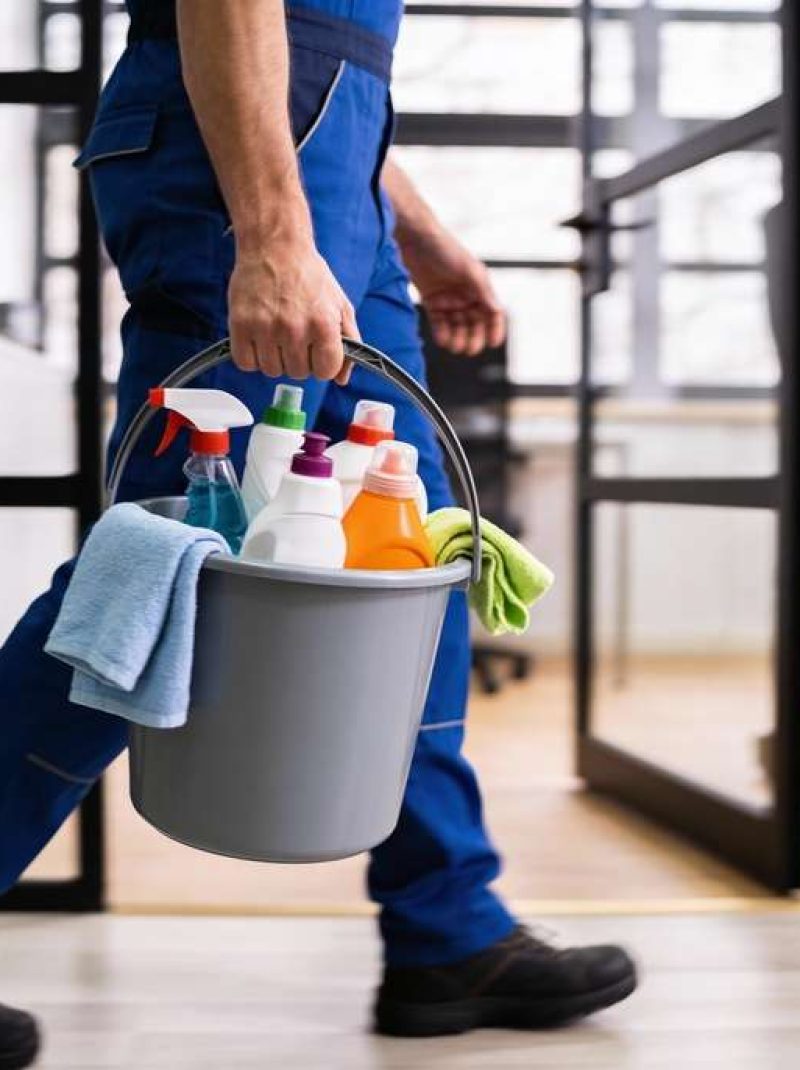Professional,Cleaning,Worker,Wearing,Uniform,And,Walking,Indoors,While,Carrying