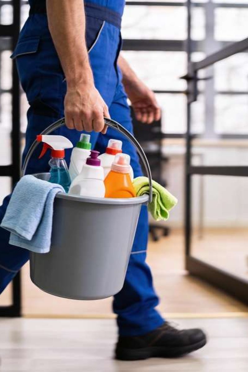 Professional,Cleaning,Worker,Wearing,Uniform,And,Walking,Indoors,While,Carrying