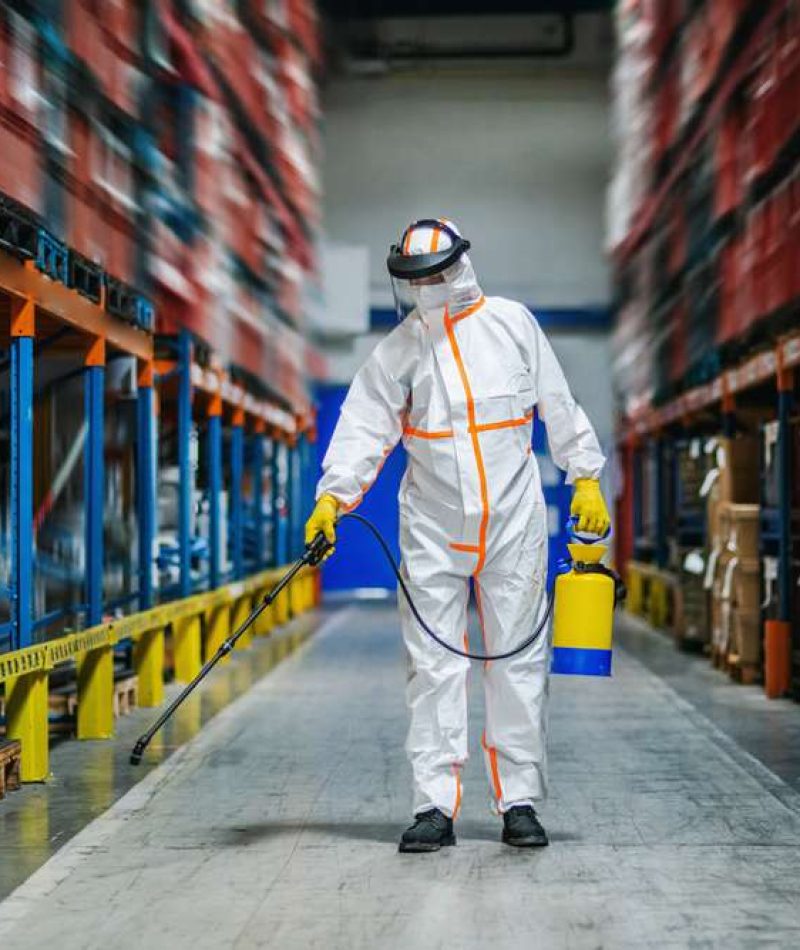 Man,Worker,With,Protective,Mask,And,Suit,Disinfecting,Industrial,Factory