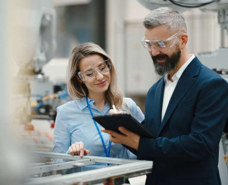 Female,Engineer,And,Male,Production,Manager,Standing,In,Modern,Industrial